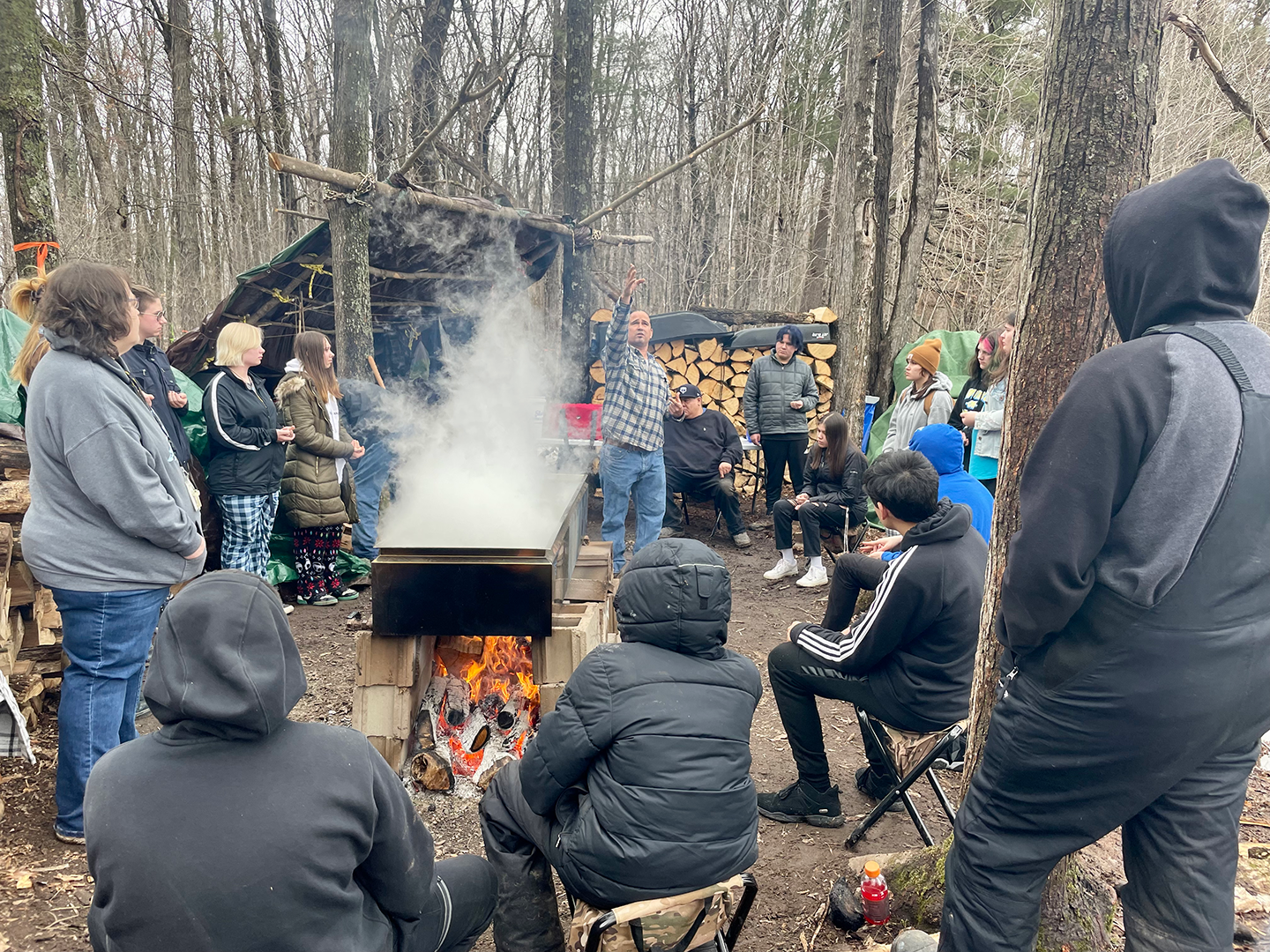 Culture instructor teaching students about sugar camp
